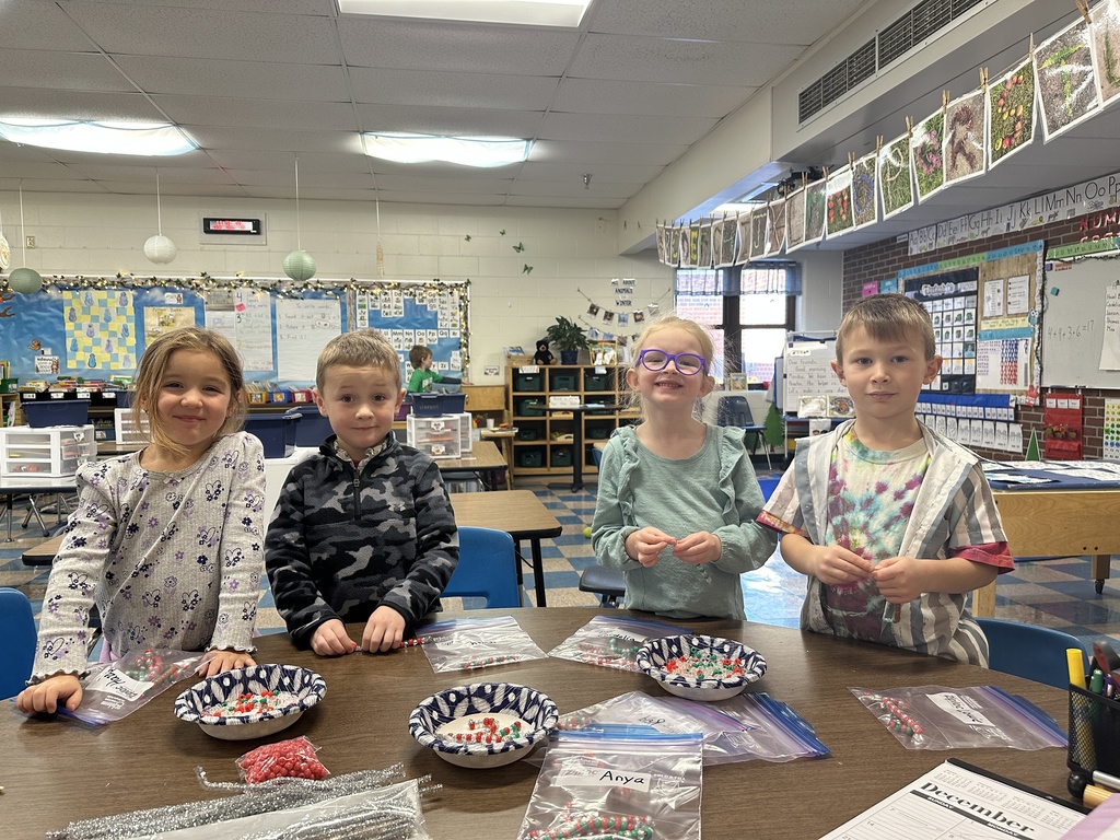 Having fun making candy canes with beads in kindergarten 