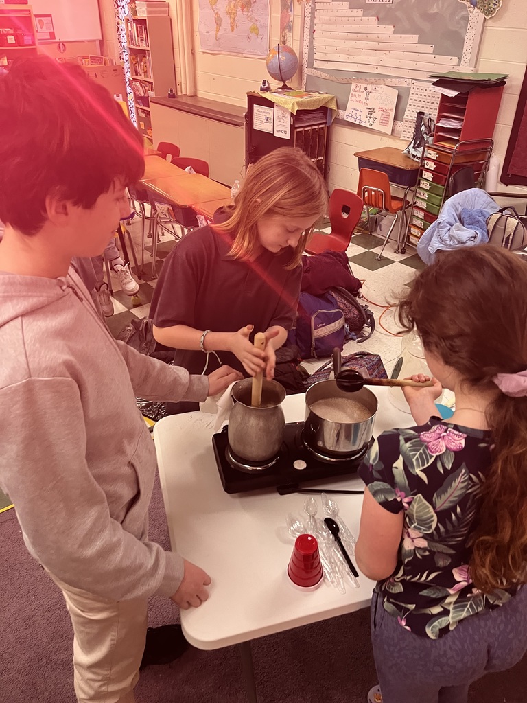 Lincoln academy international students conversing with 5th and 6th graders while sipping on Colombian hot chocolate that traditionally includes adding mozzarella cheese!