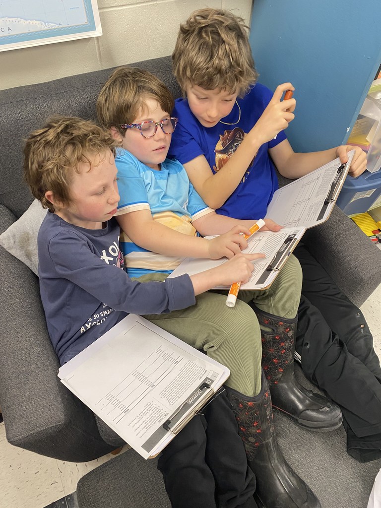 Fourth graders working together in Ms. Jen's room to solve a VERY challenging math problem!