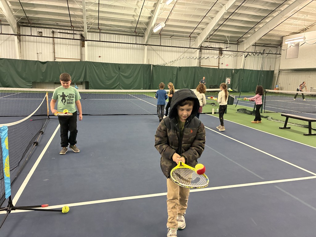 2nd graders learning some tennis skills at the Y!