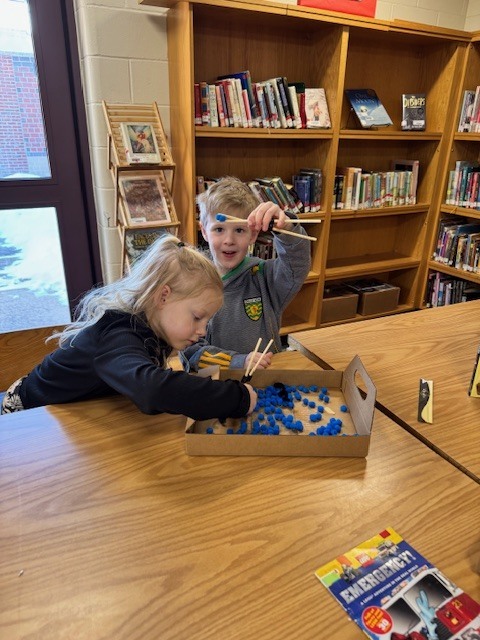 Mrs Ball's class practiced with tricky chopsticks" of their very own after reading the Chickadee Award nominated "Tricky Chopsticks" by Sylvia Chen.