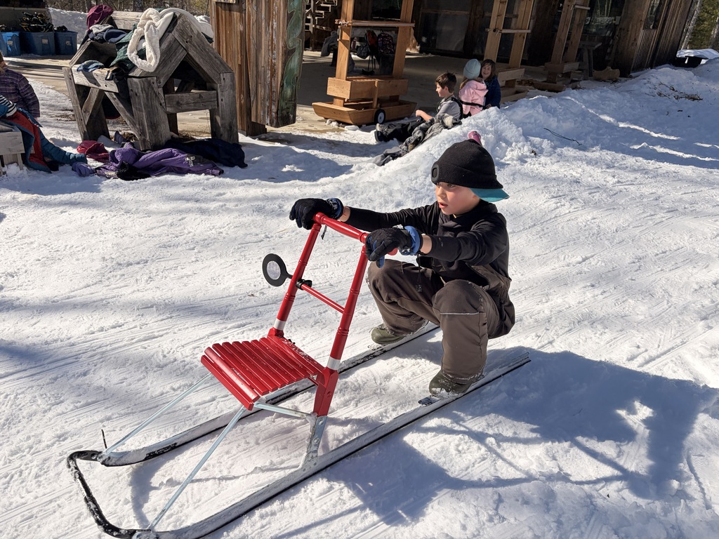 Mr. Coleman's class at HVNC having fun on kick sleds and tracking an otter through the snow.