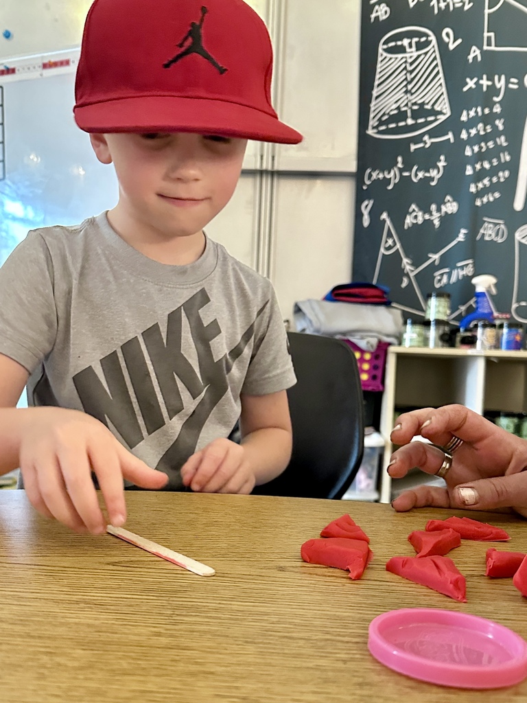 1st grade students practice fractions with play dough