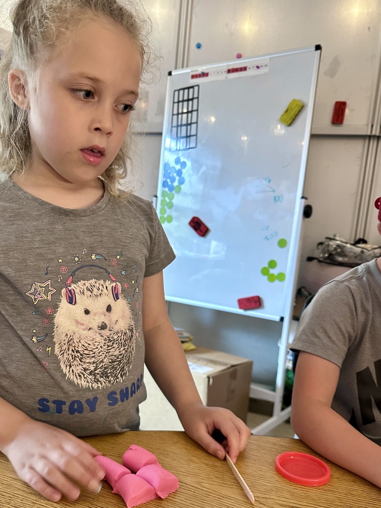 1st grade students practice fractions with play dough