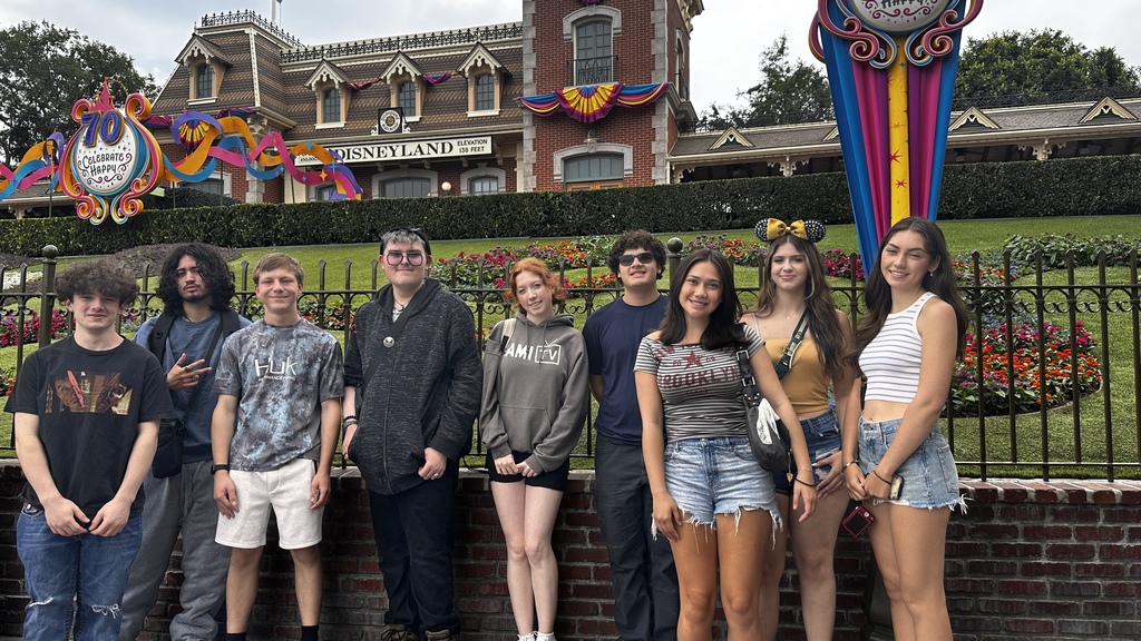 students standing in front of disneyland