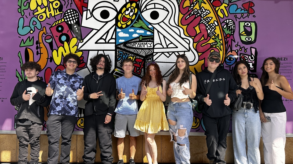students standing In front of street art