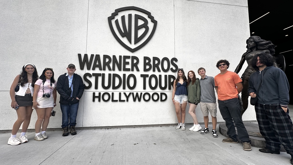 students standing in front of warner bros studio