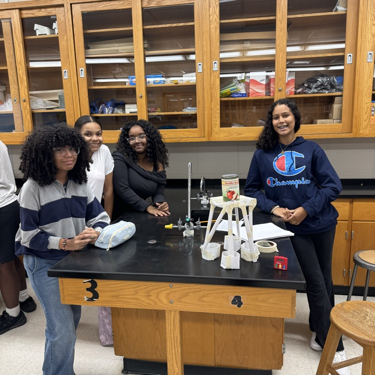 Students with paper tower supporting a can