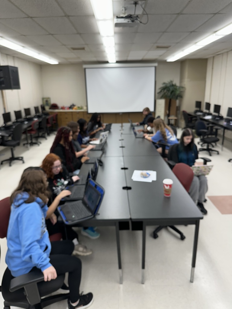 students gather at a table to prepare for a job fair