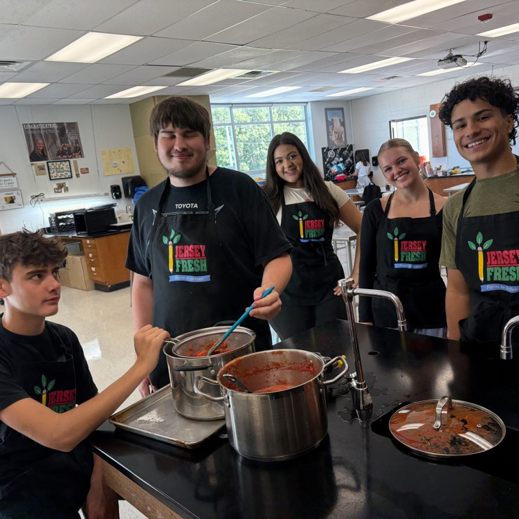 students gather around tomatoes