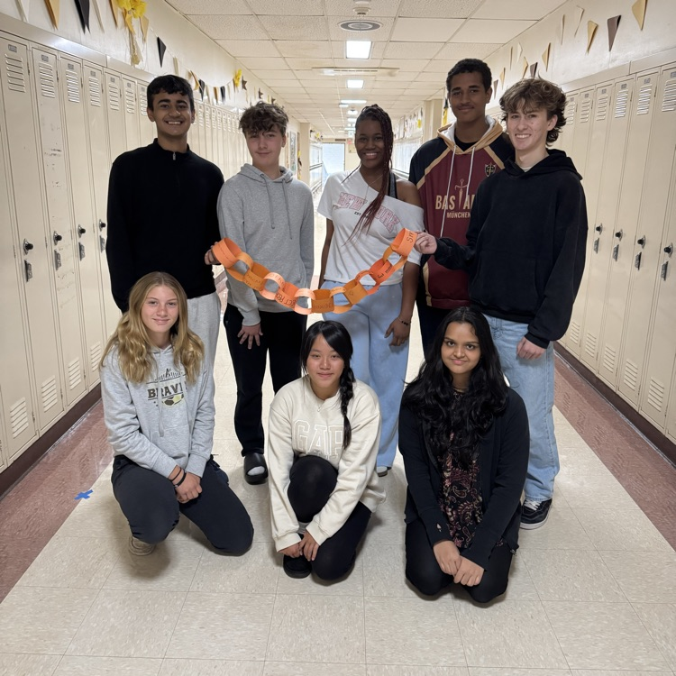 group of students holding a chain