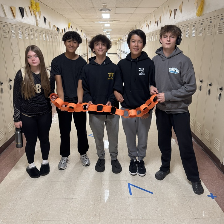 group of students holding a chain