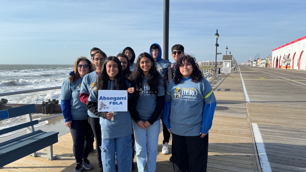 fbla group stands together on boardwalk
