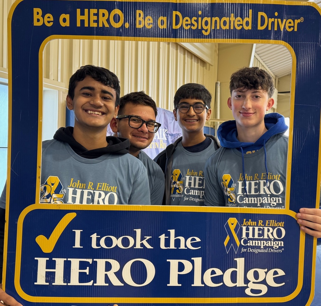 4 boys stand together in a frame that says be a hero
