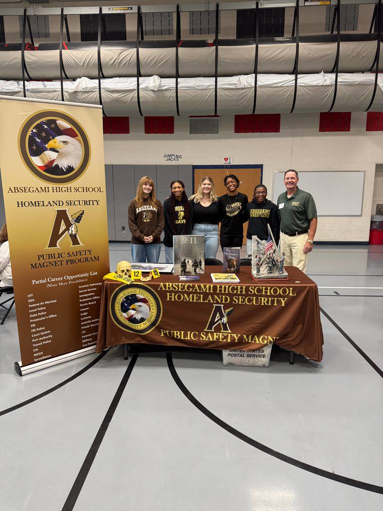 people standing with a banner promoting a magnet