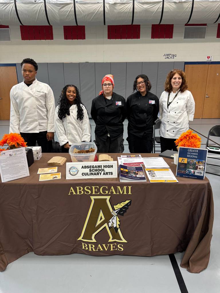 people standing with a banner promoting a magnet