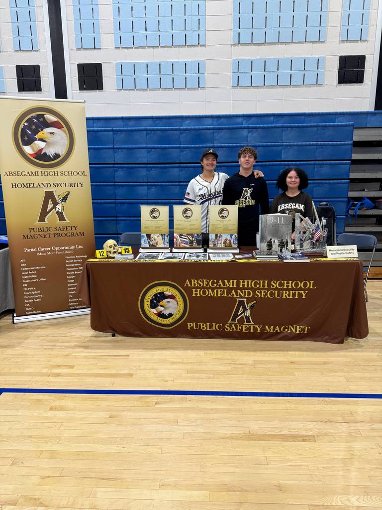 people standing with a banner promoting a magnet