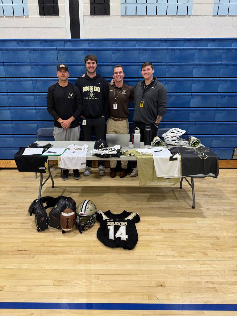 people standing with a banner promoting a sport
