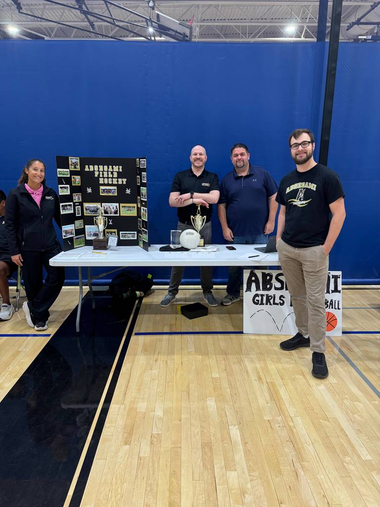people standing with a banner promoting a sport