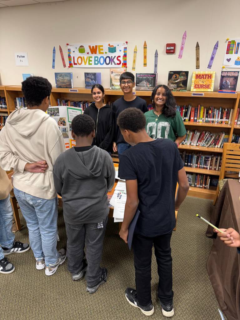 people standing with a banner promoting a magnet