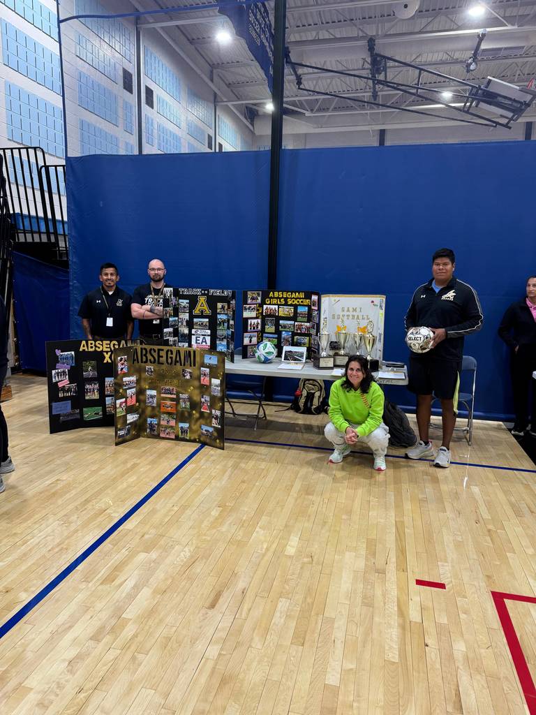 people standing with a banner promoting a sport