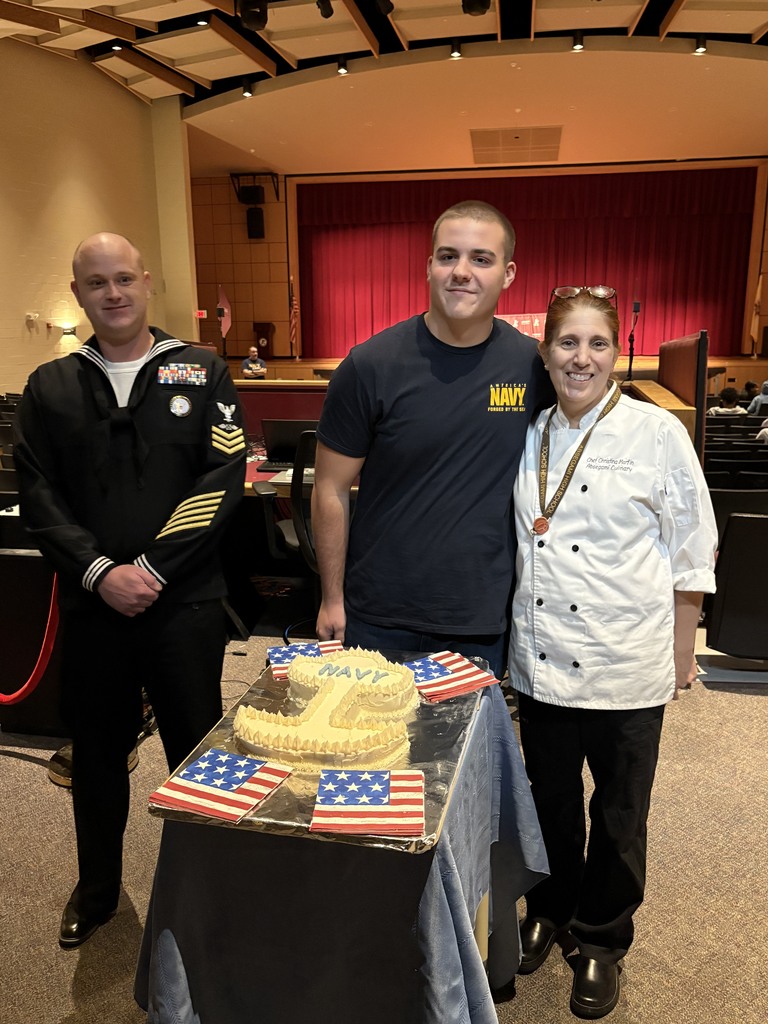 matt standing with chef martin and a navy cake