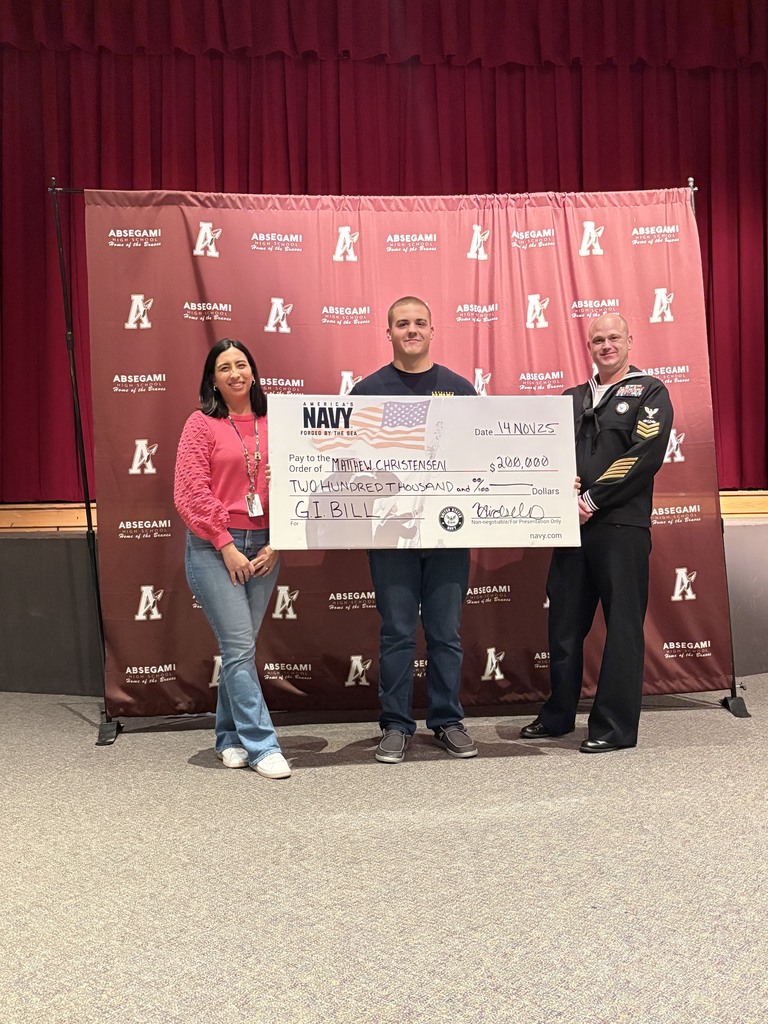 Matt standing with a check from the Navy
