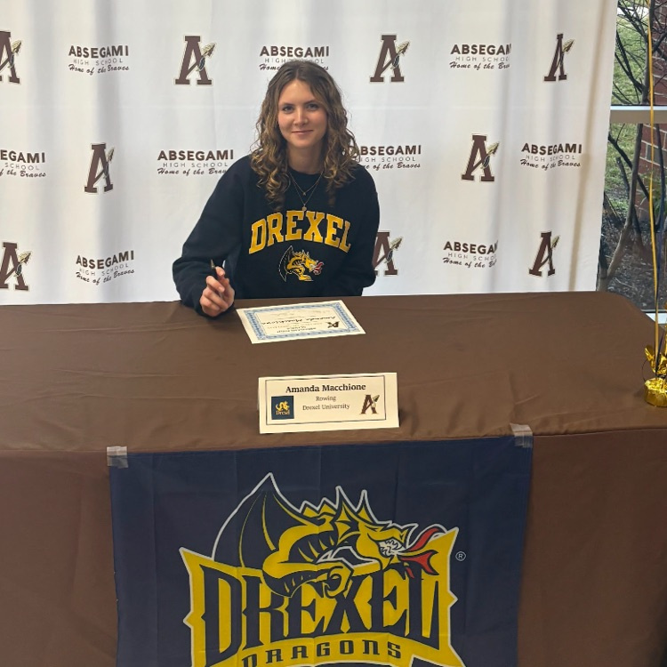 student signing to Drexel