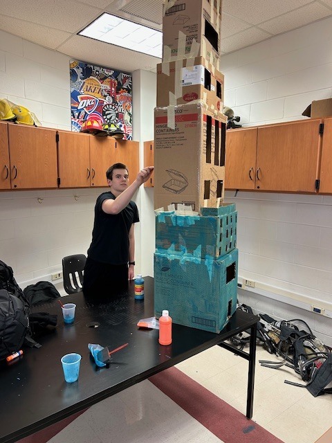 The firefighting students are building structures to predict fire behavior. 