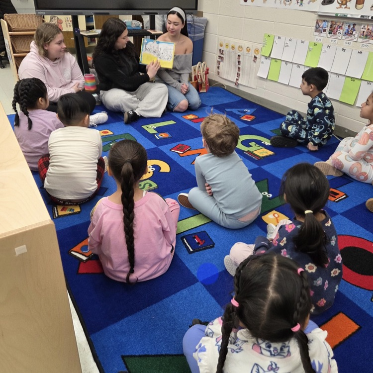 NHS members reading to preschool students