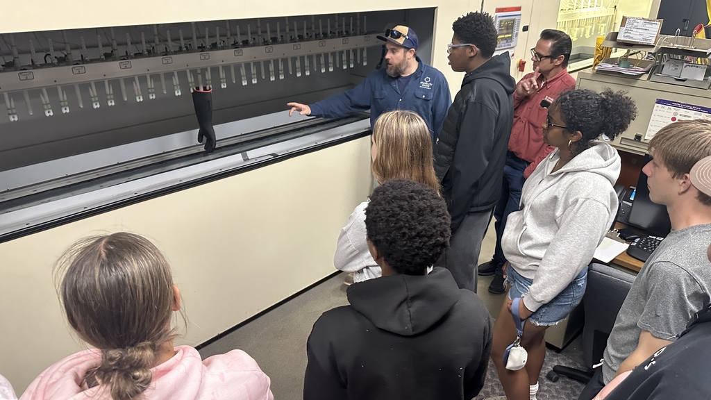 students gathered around ACE machine