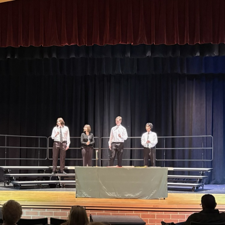 four students taking the oath of the German Language Honor Society
