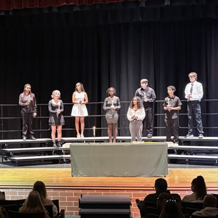 Eight students taking the oath of the Spanish Language Honor Society