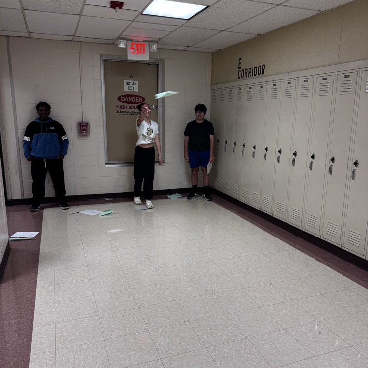 Student flying a paper airplane