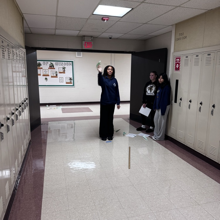 Student flying a paper airplane