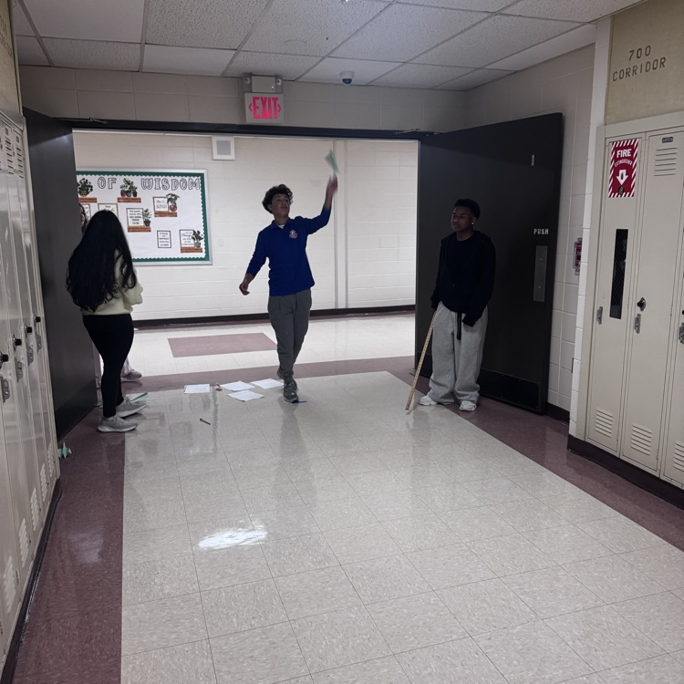 Student Flying a Paper Airplane