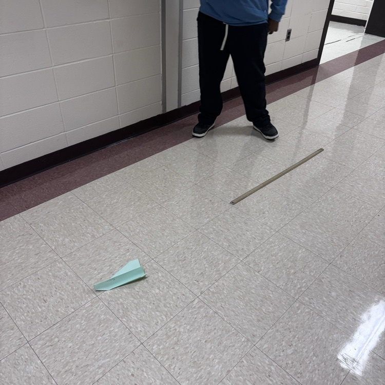 Paper airplane with a meter stick