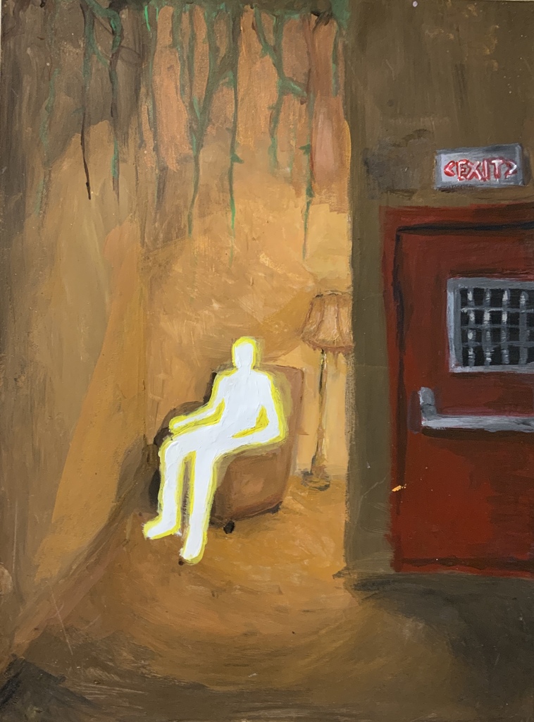A man sits in a chair with yellow lighting, beside a lamp and a door.