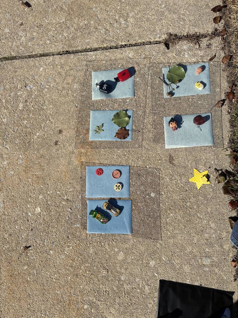 Small, square pieces of paper with various small objects on them.