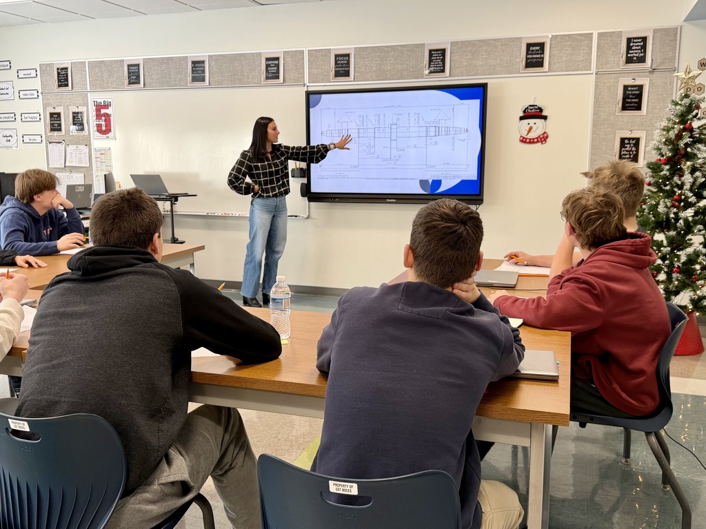 Emily showing a drawing to students in NVE!