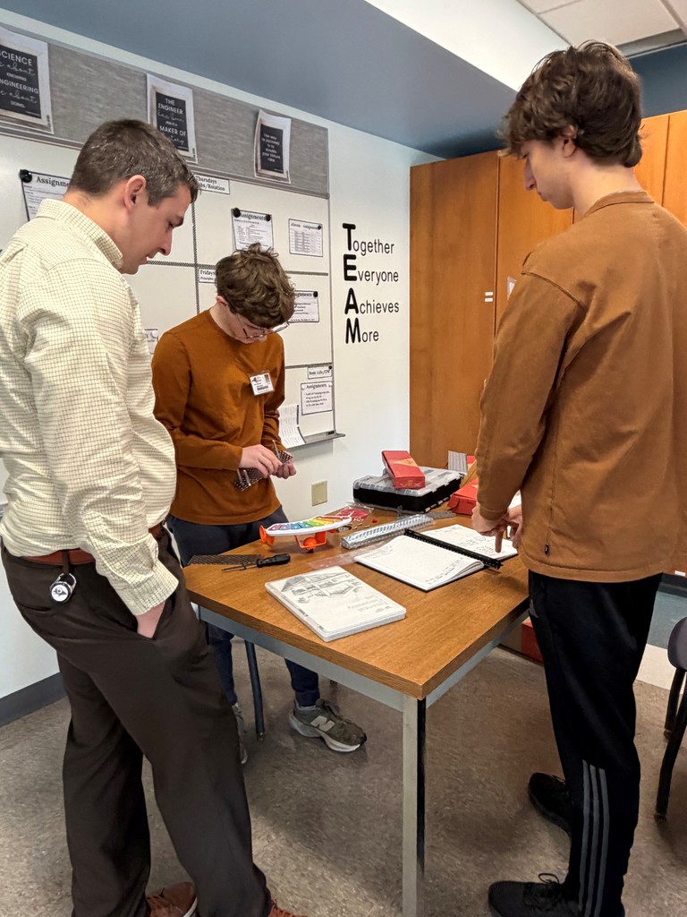 School Counselor Mr. Gallagher gets a hands on lesson in engineering from New Visions students.
