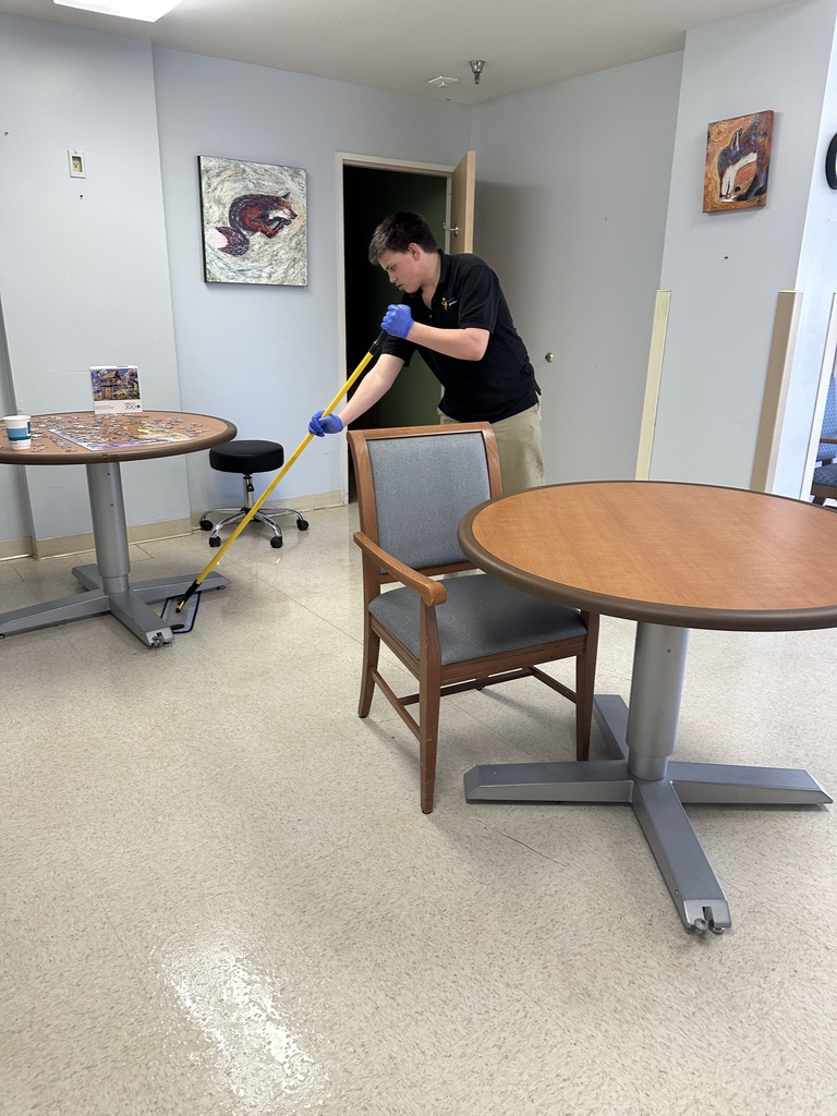 Intern mopping floor