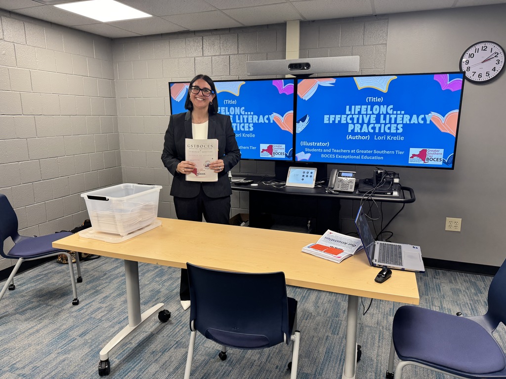 Lori standing in front of her presentation .