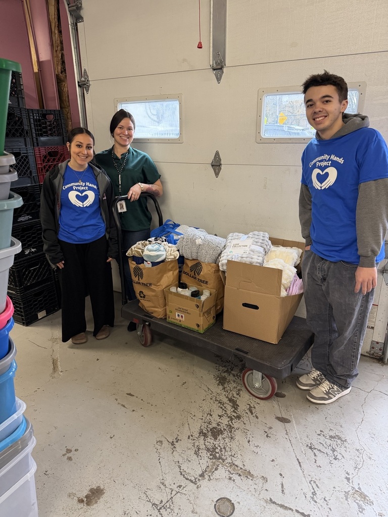 Three people standing with donations