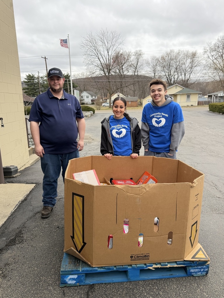 Three people standing with donations