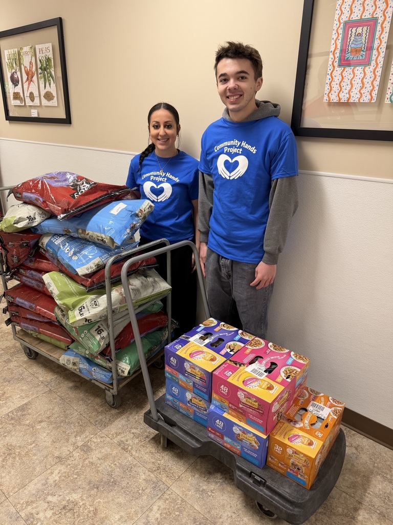 Two students standing with goods purchased