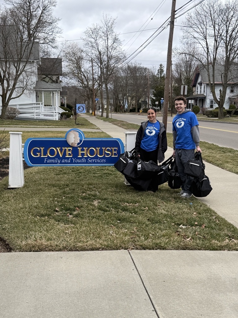 two people with donations for Glove House