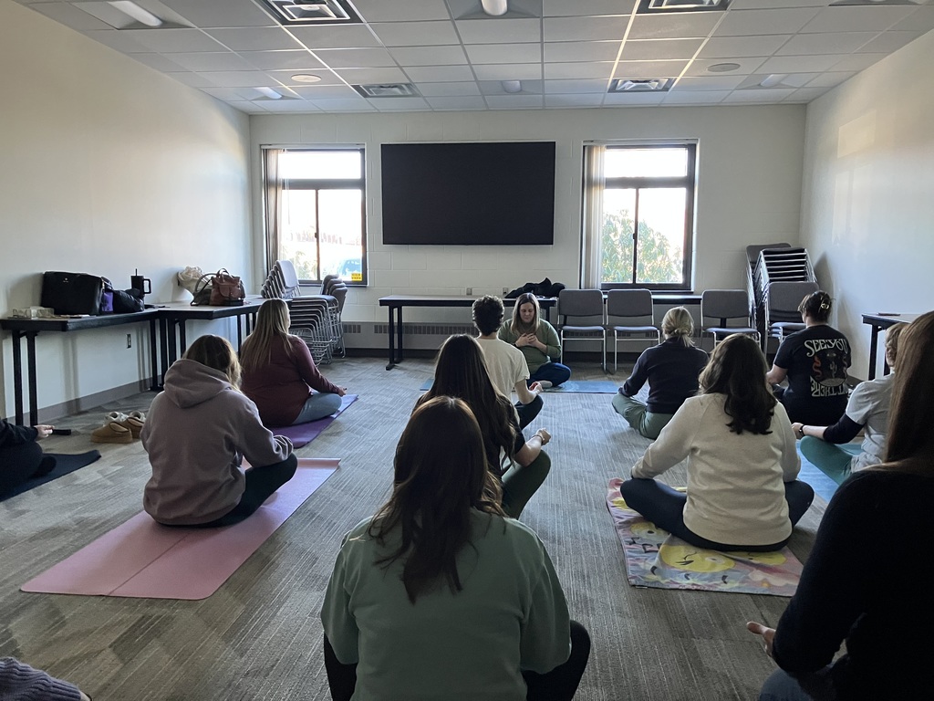 Class sitting in a yoga pose
