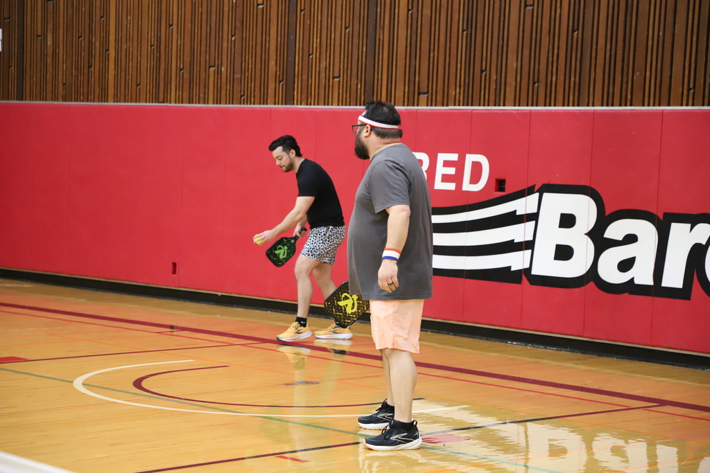 Two staff playing pickleball 