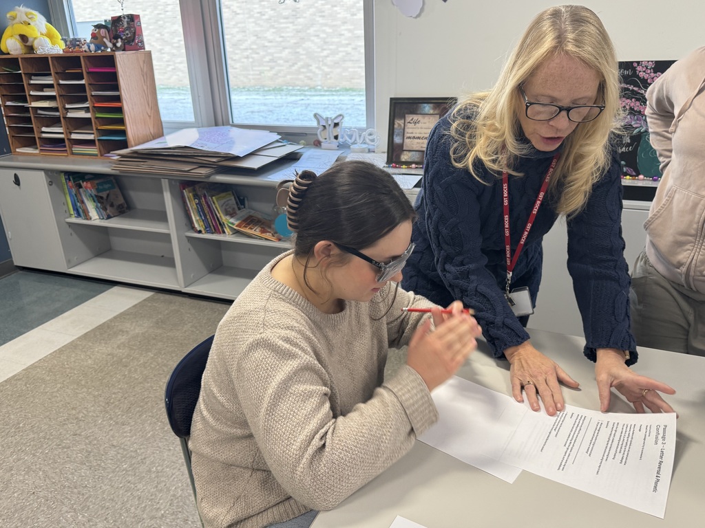 A student trying to read with glasses to blur her vision.